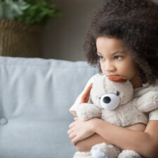 Stressed child holding teddy bear