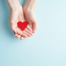 Hands holding paper heart; how to find love