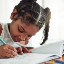 Girl coloring in a coloring book to relieve stress