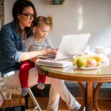 Work at home mom with daughter on lap