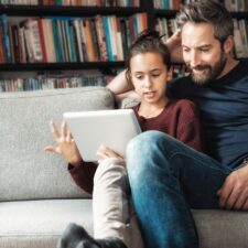 Dad with daughter using creativity app for kids