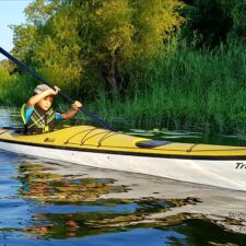 Little boy paddling the Trinity River