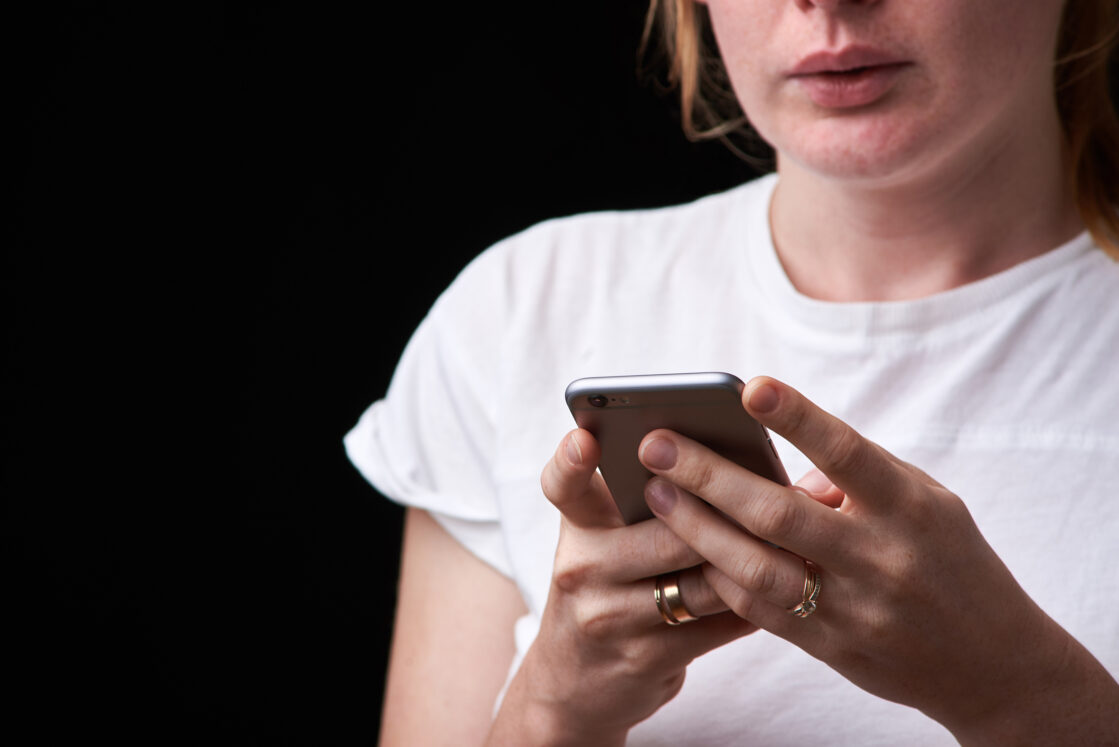 How to Respond to Mom-Shaming on Social Media, iStock image of upset pregnant woman with phone in her hands. technology and pregnancy. pregnancy, motherhood, technology, people and expectation concept - sad pregnant woman calling on smartphone at home