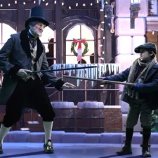 A Christmas Carol: A New Musical Comedy, at Casa Mañana, Pictured: Dirk Lumbard as 'Ebenezer Scrooge,' Charlie Bilbow as 'Tiny Tim.' Photo by Agency Habitat.