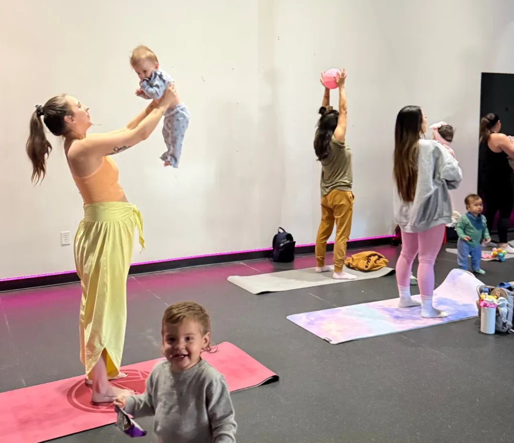 Moms and their babies and toddlers in a Baby & Me Pilates class at Sun Rabbit Yoga studio in Dallas