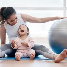 iStock image of mom and her baby with yoga ball, Mommy & Me Classes in Dallas-Fort Worth