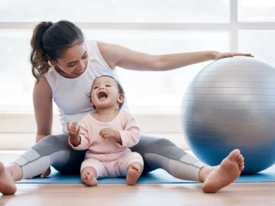 iStock image of mom and her baby with yoga ball, Mommy & Me Classes in Dallas-Fort Worth