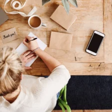 iStock image of woman writing thank-you notes, for manners advice column