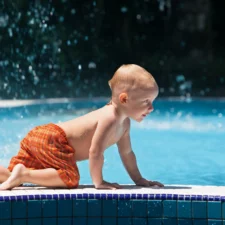 iStock photo of active baby having fun in swimming pool