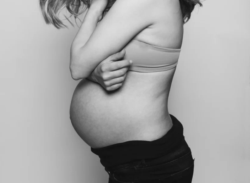 iStock of woman with pregnant belly, image for our week-by-week pregnancy guide