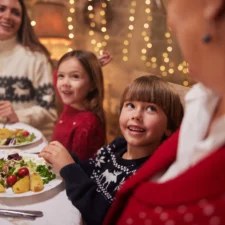 iStock image of family at restaurant during the holidays; The Best Family-Friendly Restaurants for Christmas Dinner in Dallas,