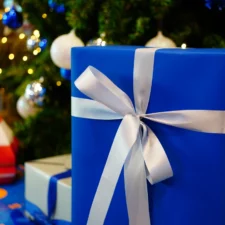 iStock image of blue and silver gift box under Christmas tree, Dallas Cowboys gift guide for fans of all ages