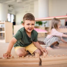 Group of small nursery school children playing indoors in classroom, Montessori learning. iStock photo