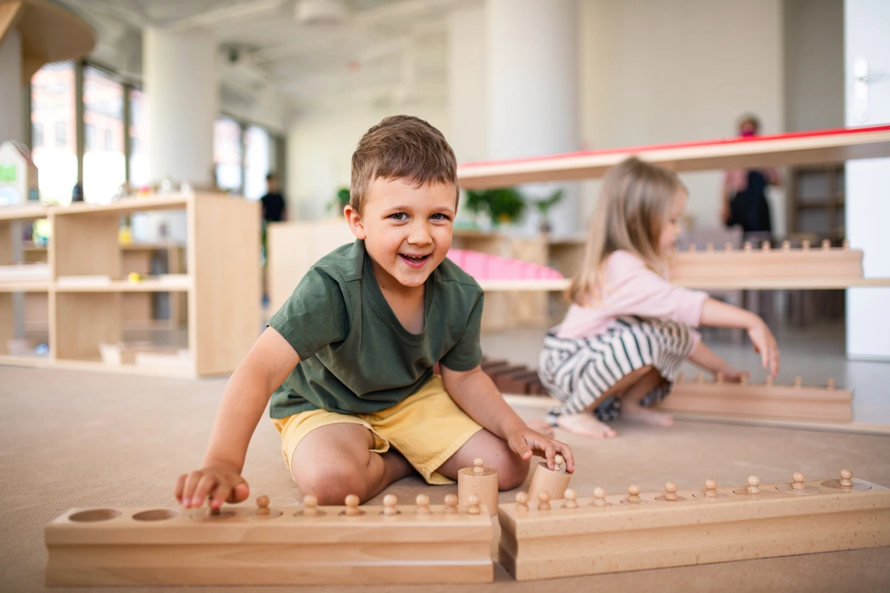 Group of small nursery school children playing indoors in classroom, Montessori learning. iStock photo