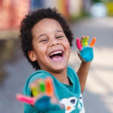 iStock image of beautiful happy boy with painted hands stock photo