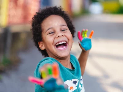 iStock image of beautiful happy boy with painted hands stock photo