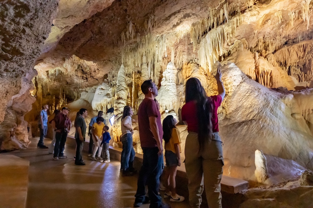 Family travel vacation destination to New Braunfels, Texas. The Cathedral Room's colors are significantly more visibile thanks to the new lighting on the Hidden Wonders tour at Natural Bridge Caverns