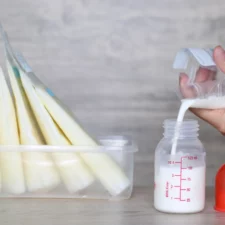 iStock image of pouring thawed breastmilk into a baby bottle, for article on common, alternative uses for breastmilk