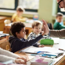 iStock image of children in classroom with teacher, making a good first impression with teacher