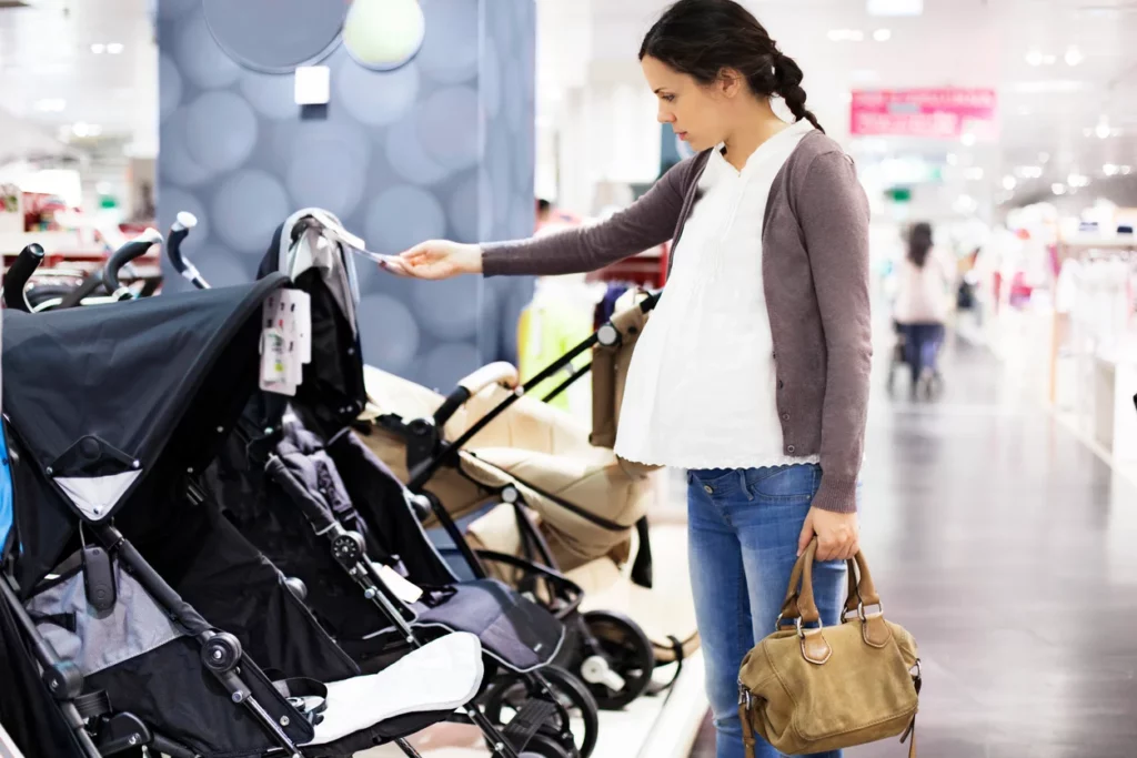woman testing baby strollers, iStock