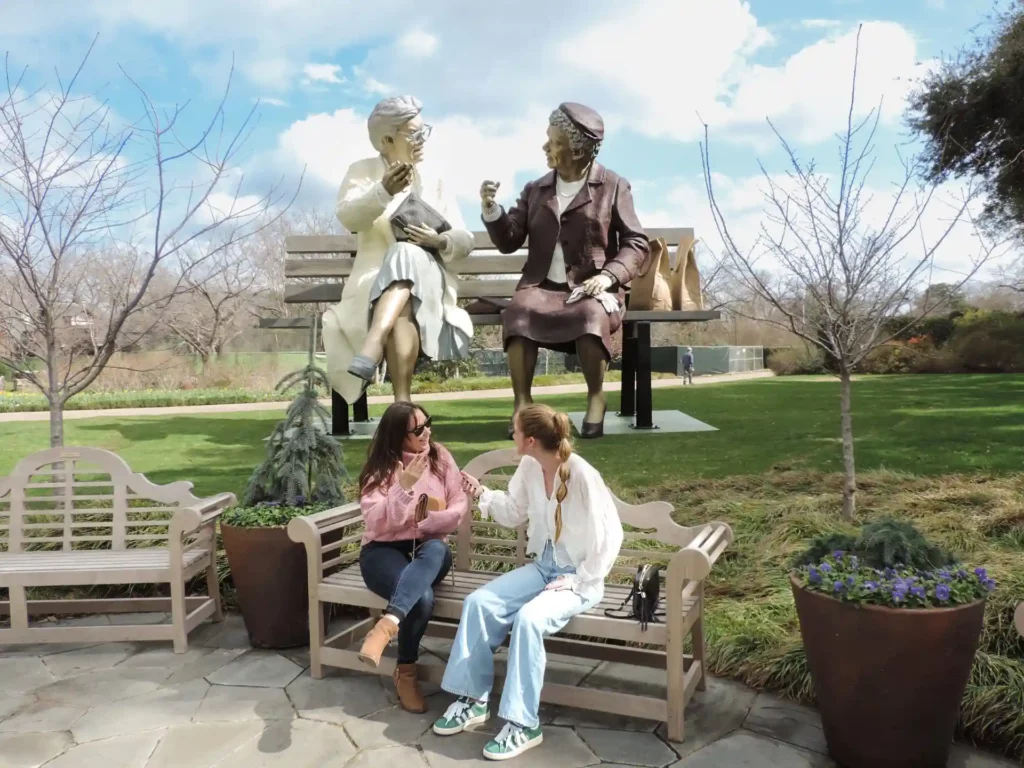 20-foot-tall sculpture Crossing Paths, by Seward Johnson, on display at Dallas Arboretum during its 2025 Dallas Blooms festival