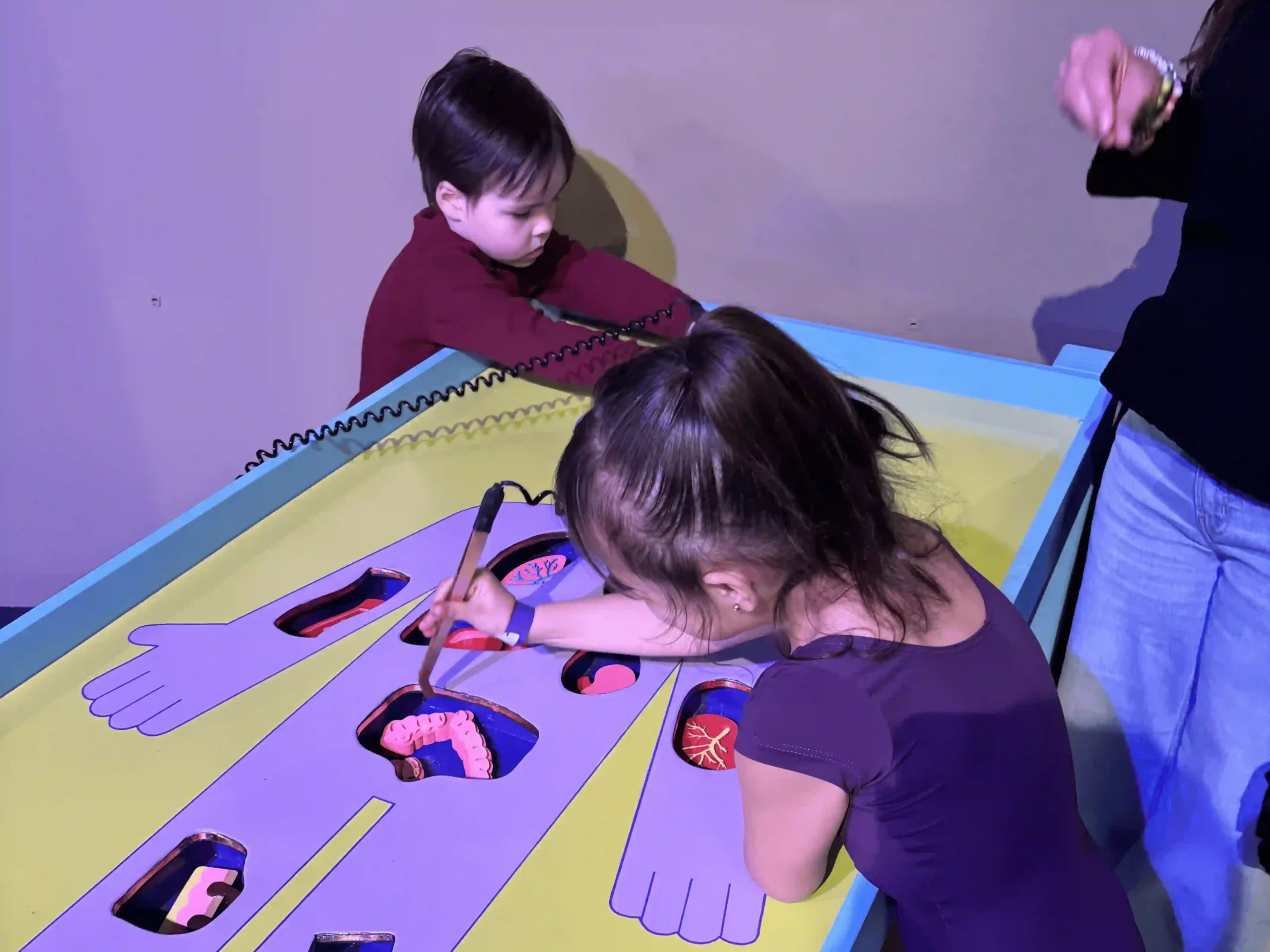 children playing with educational apparatus at Frisco Maker Faire at the Sci-Tech Discovery Center