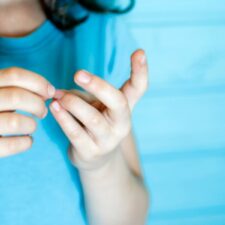 iStock The child cleans dirt from under his nails stock photo