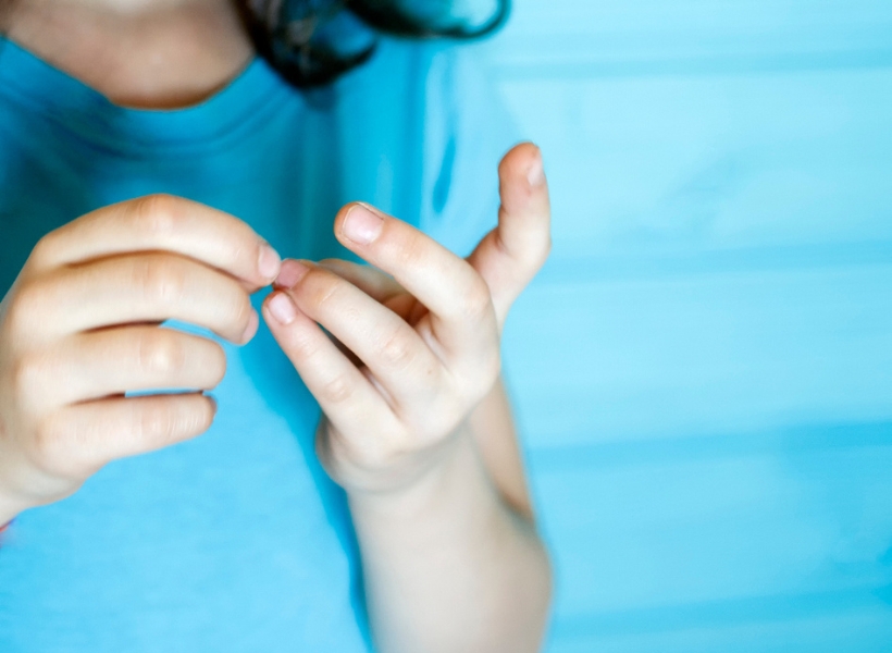 iStock The child cleans dirt from under his nails stock photo