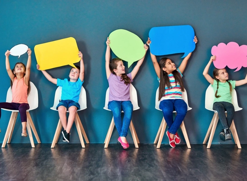 iStock image, of children holding up signs to express themselves, for article on self-advocacy