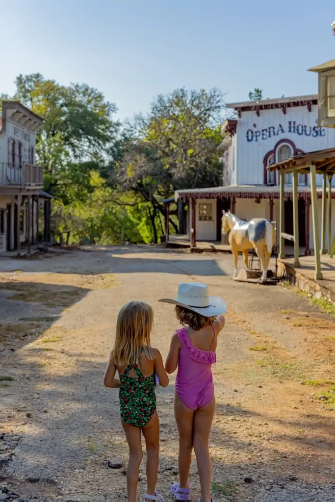 Swimsuit-clad kids exploring the Western town at 7A Ranch in the Texas Hill Country, photo courtesy Casey Chapman