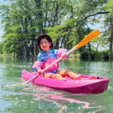 Child kayaking along the Frio River in the Texas Hill Country, photo courtesy of Rio Bella Resort