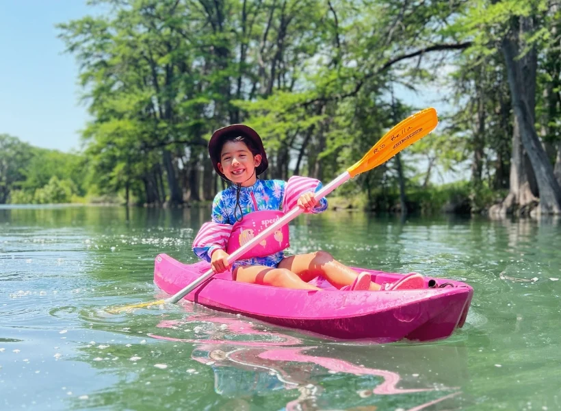 Child kayaking along the Frio River in the Texas Hill Country, photo courtesy of Rio Bella Resort