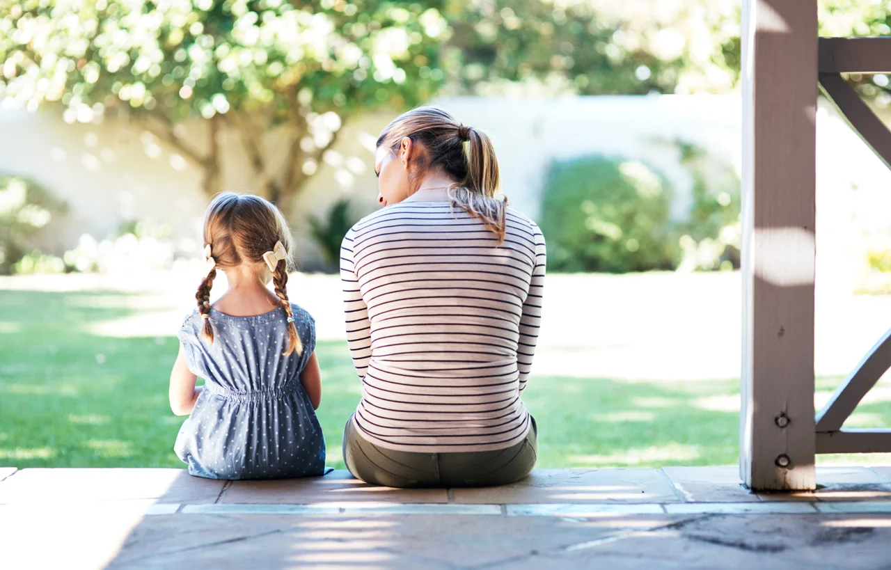 iStock image, rearview shot of a young woman and her daughter having a conversation on the porch