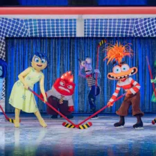 Live action characters from Inside Out, on the ice rink playing hockey in the Disney on Ice performance