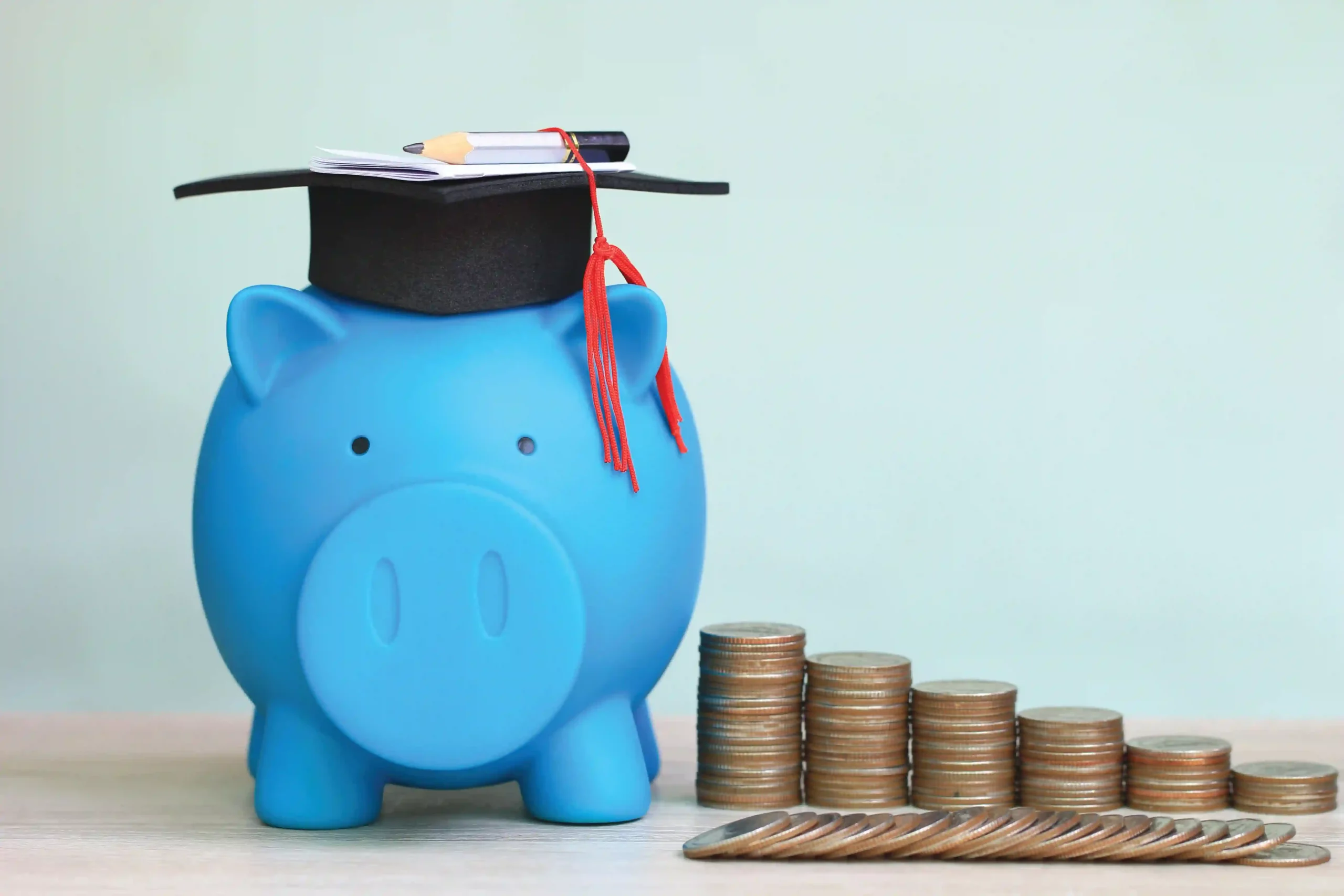 iStock image of piggie saving bank wearing graduation cap, for article on how Texas parents can saving money for college through a 529 plan