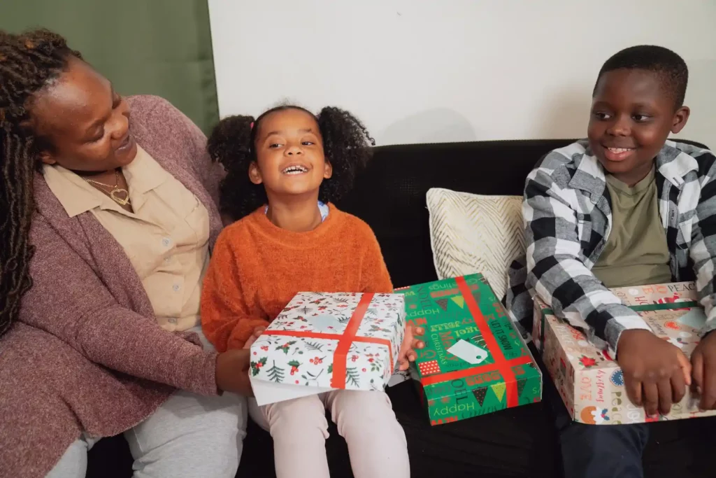A mother and her children opening gifts on Christmas morning, from Angel tree program, photo courtesy The Salvation Army