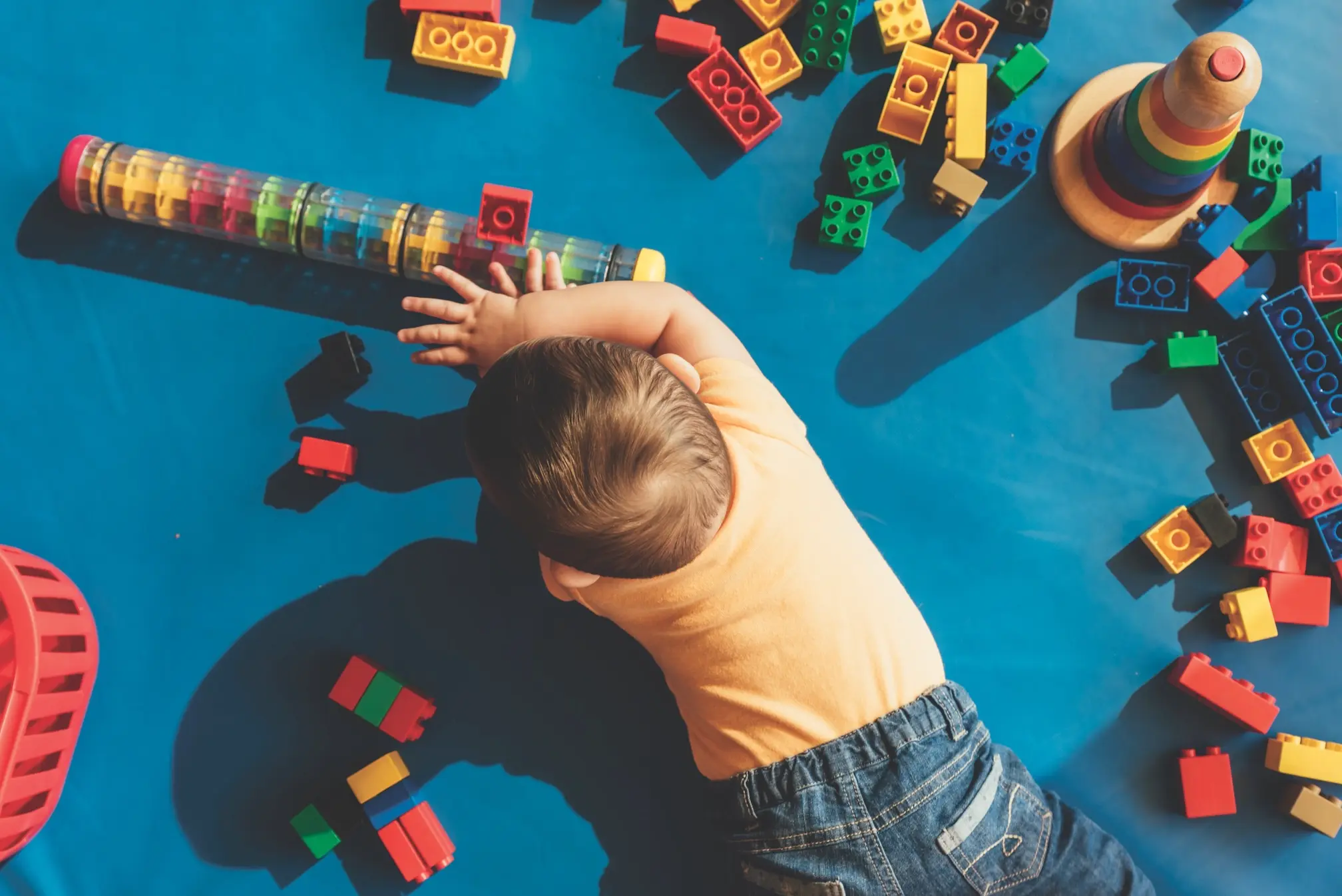 iStock image of baby on the floor playing with toys