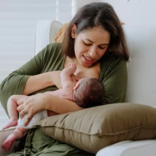 iStock image of a new mother breastfeeding a newborn, for article with a lactation expert's advice on how to know whether you're making enough breast milk