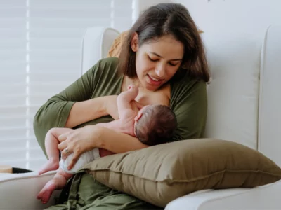 iStock image of a new mother breastfeeding a newborn, for article with a lactation expert's advice on how to know whether you're making enough breast milk
