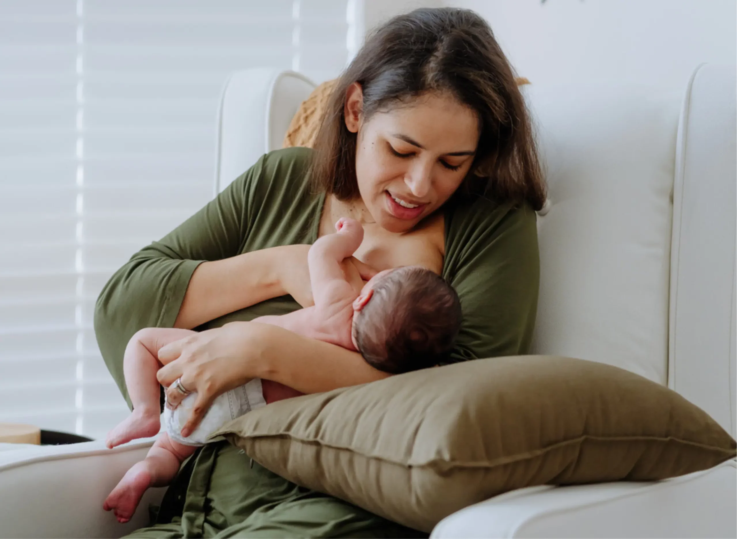 iStock image of a new mother breastfeeding a newborn, for article with a lactation expert's advice on how to know whether you're making enough breast milk