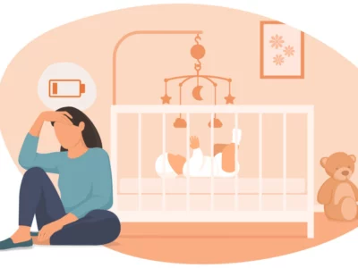 iStock illustration depicting a tired mother sitting on the floor beside her baby's crib, for article on Self-Care for Sleep Deprived  