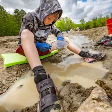 Crater of Diamonds, Boyd with strainer in water, photo credit_courtesy of the Arkansas Department of Parks, Heritage and Tourism