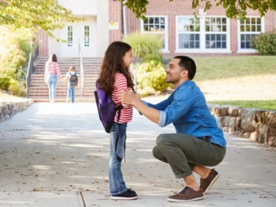 iStock image of father with daughter outside of a school building