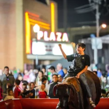 A child riding a mechanical bull in the downtown Carrollton square for the annual TEXFest in Downtown Carrollton