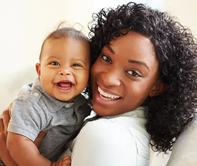 Mom and her baby, both smiling