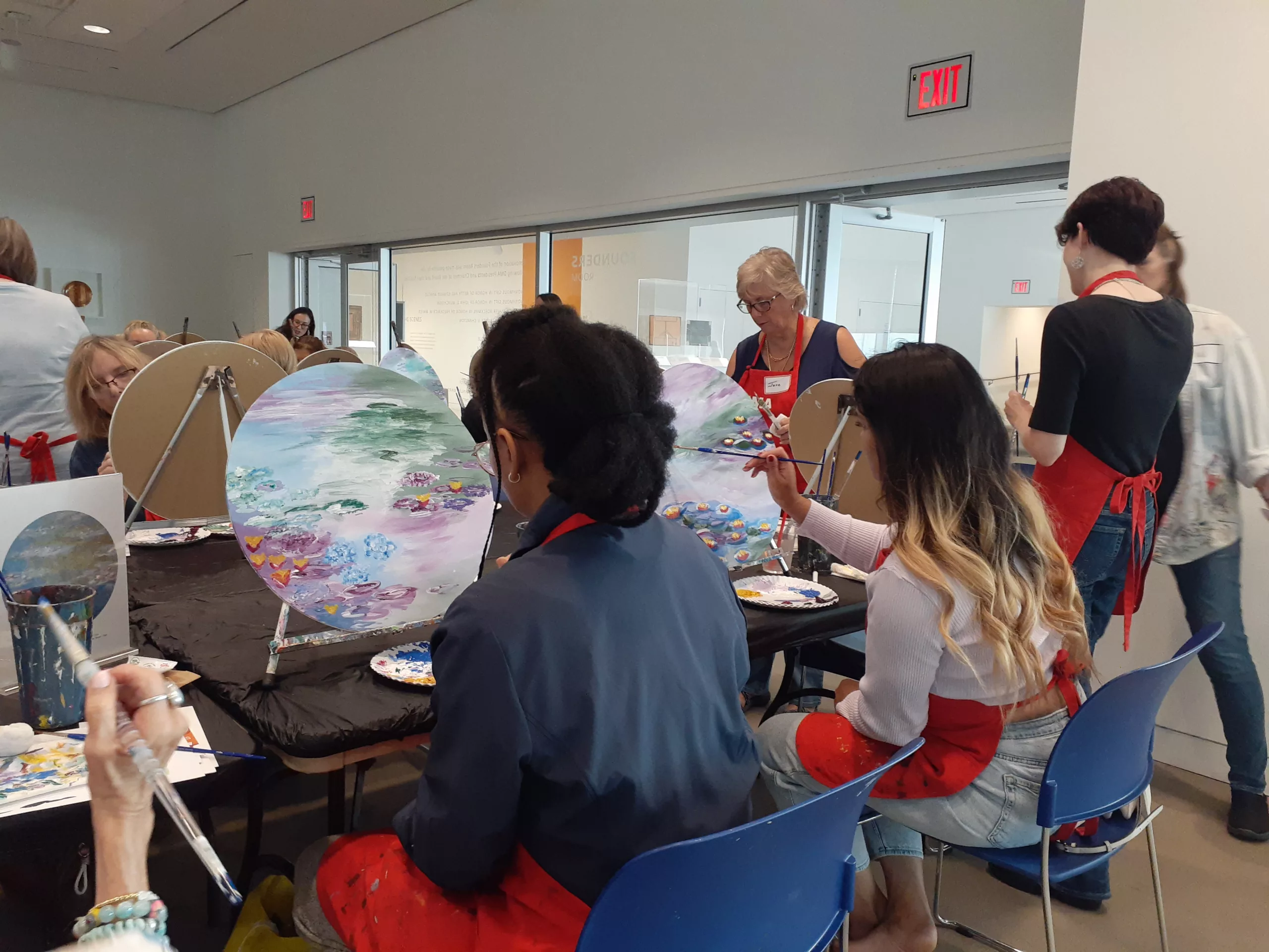 Museum patrons painting in an adult workshop