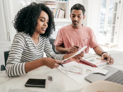 A couple working on their taxes indoors, for article on whether and how you claim summer camp on taxes